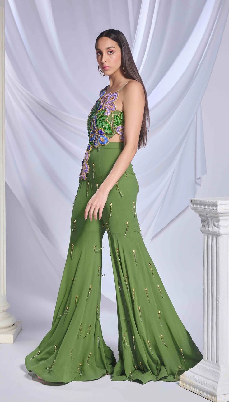 One shoulder top in moss green, heavily adorned with hand embroidered 3D flowers, beads and crystals. Paired with a matching georgette gharara.From Papa Don’t Preach’s Bring Your Own Fairytale collection. DELIVERY TIMEPlease allow 8-12 weeks for your outfit to arrive. FABRIC DETAILSGeorgette Professional cleaning only. Green Gharara, Gharara Pants, Papa Don't Preach, Flowers Beads, Floral Patchwork, Ethnic Outfits, Sharara Set, 3d Flowers, One Shoulder Tops