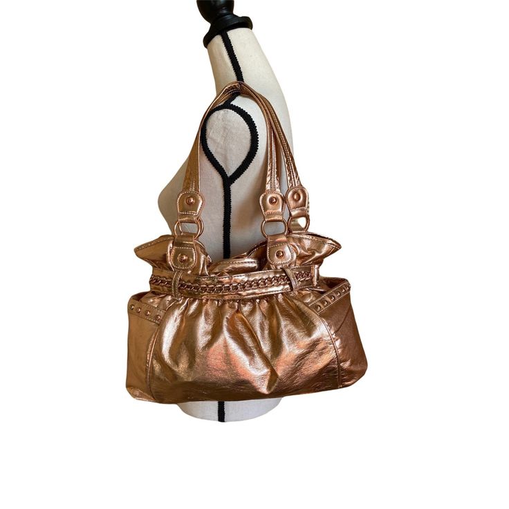 Vintage Y2K hobo bronze metallic  fashion shoulder handbag OS Features: * Bronze tone metallic  fashion handbag * Embellished with a faux metallic gold chain in the front * Vintage, it has a minor stain in the lining inside, nothing noticeable. * Synthetic resistant material * No stains nor damages in the outside, mint condition * Made in China * Pockets in the inside, a lot of room for belongings * Snap on closure Measurements: Length: 13 in / 33 cm Width 4 in / 10 cm Height 9 in / 23 cm Handle Gold Hobo Bag For Formal Occasions, Gold Hobo Shoulder Bag For Party, Gold Formal Hobo Shoulder Bag, Formal Gold Hobo Shoulder Bag, Gold Formal Shoulder Hobo Bag, Gold Bucket Shoulder Bag With Gold-tone Hardware, Gold Shoulder Bag With Gold-tone Hardware Satchel, Gold Shoulder Bag With Gold-tone Hardware For Shopping, Gold Hobo Bag For Evening