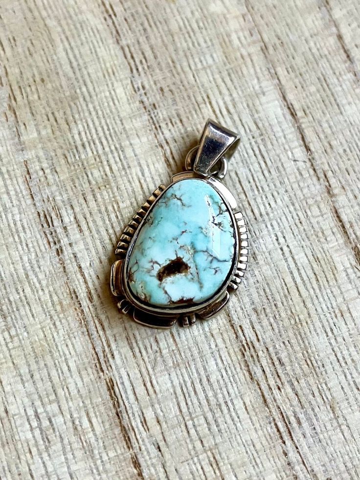 This vintage Small Navajo Sterling silver pendant features a rare high polish Dry Creek turquoise with its symbolic rare pastel blue natural color. Fine and delicate.  Please see last picture for pendant measurement, compare to quarter coin. Weight: 4.1 grams Signed: JF Sterling Dry Creek Turquoise comes from a small Turquoise mine outside of Austin, Nevada in Lander County. This mine was previously known for its sky blue to medium blue webbed turquoise. Dry Creek Turquoise has gained much popularity over the years with its creamy pale blue coloring and golden to cocoa brown matrix. This color of Turquoise was rarely used in Turquoise Jewelry before the late 1990s. The color is a pastel blue much like the color of Larimar, only high grade Dry Creek Turquoise has beautiful light brown, gold Southwestern Style Collectible Jewelry With Large Stone, Southwestern Style Large Stone Collectible Jewelry, Vintage Untreated Turquoise Necklace, Untreated Vintage Turquoise Necklace, Untreated Southwestern Oval Jewelry, Untreated Southwestern Jewelry Collectible, Bohemian Oval Turquoise Necklace Stamped 925, Southwestern Untreated Turquoise Collectible Necklace, Southwestern Untreated Turquoise Necklace