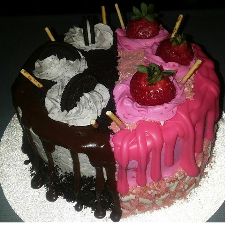 a chocolate cake with strawberries and ice cream on the top is decorated in pink icing