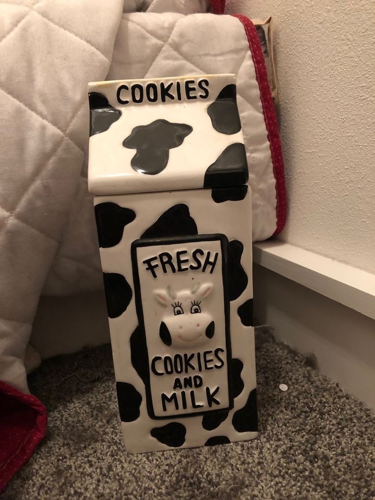 a cow shaped cookie box sitting on the floor