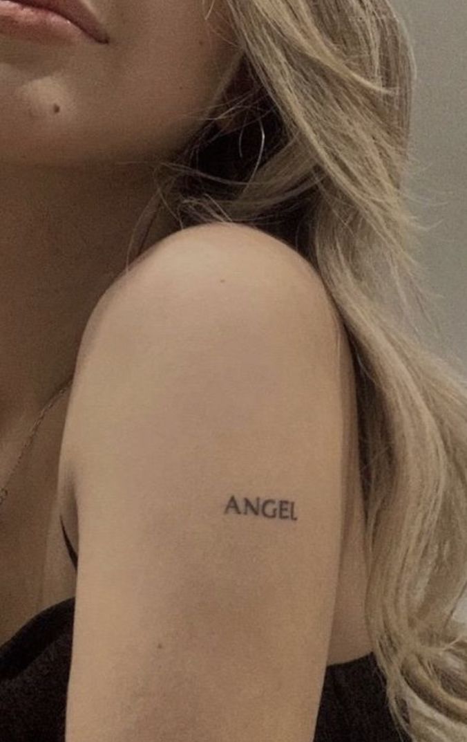 a close up of a person with a tattoo on her arm