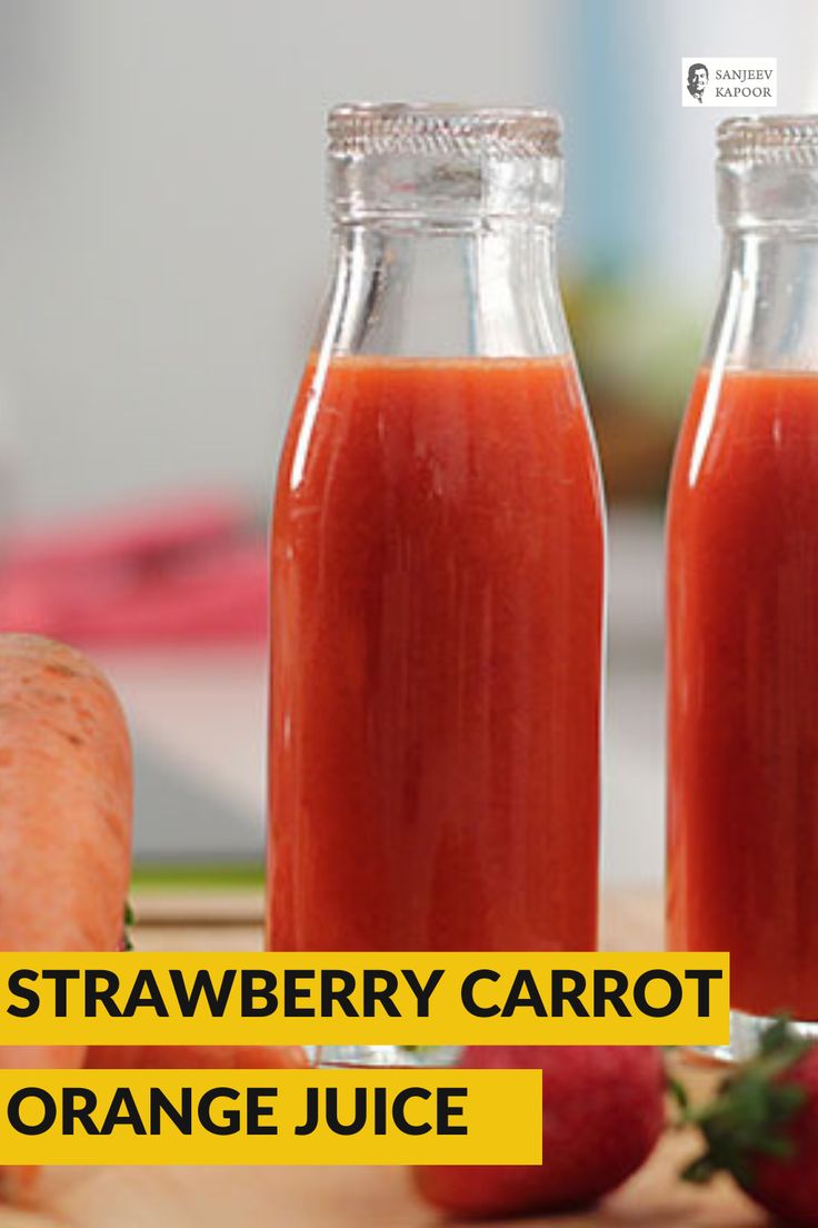 two glass bottles filled with orange juice next to carrots