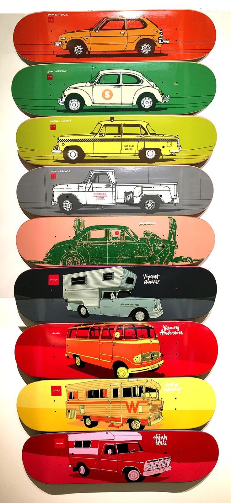 a group of skateboards with cars and trucks painted on the bottom one is multicolored