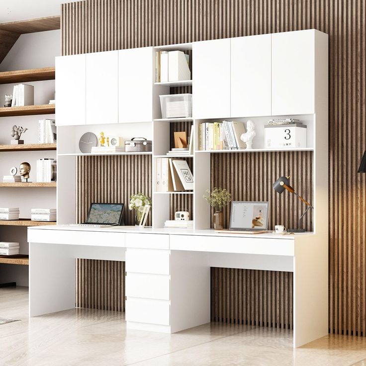 a white desk sitting in front of a book shelf filled with books and other items