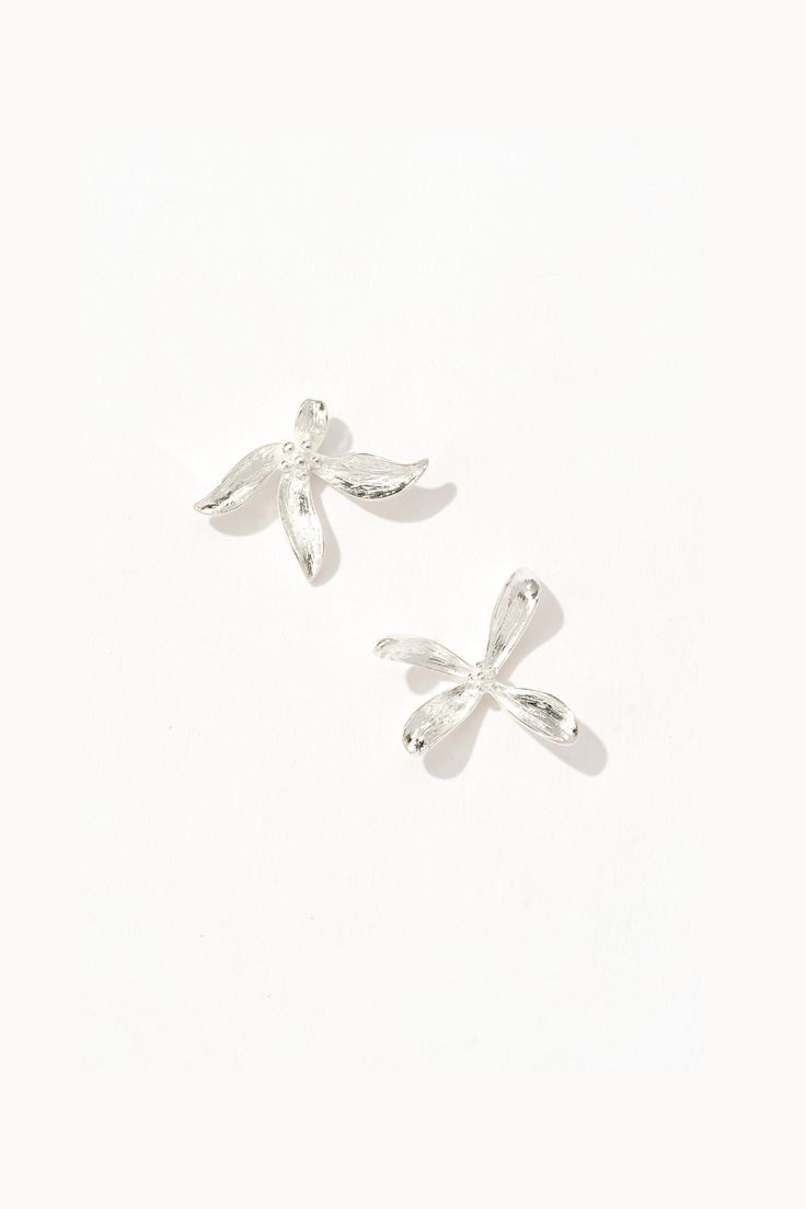 Dainty florals, kissed by silver elegance. Silver Earrings For Spring Party, Silver Earrings For Party In Spring, Silver Party Earrings For Spring, Spring Party Silver Earrings, Elegant Sterling Silver Flower Earrings For Spring, Chic Flower Earrings For Weddings, Spring Sterling Silver Earrings, Silver Feminine Flower Earrings For Formal Occasions, Chic Silver Flower Earrings For Wedding