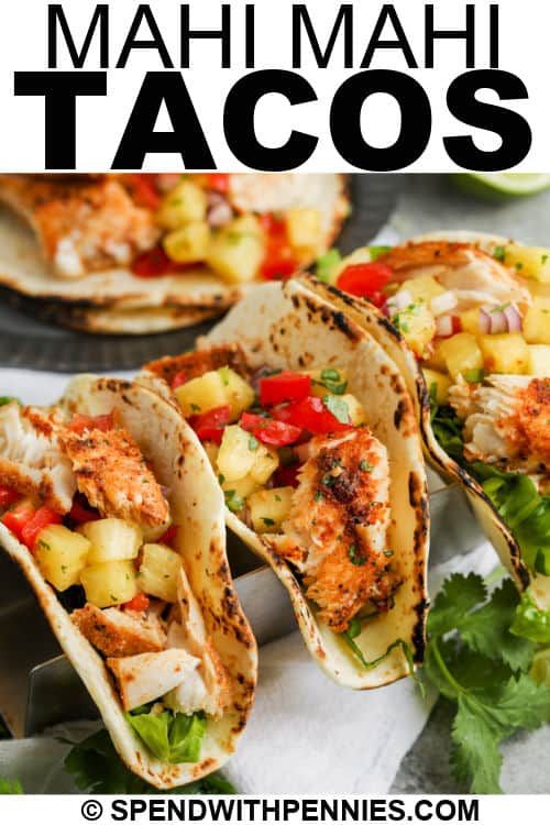 three fish tacos with pineapple salsa and cilantro on the side text overlay