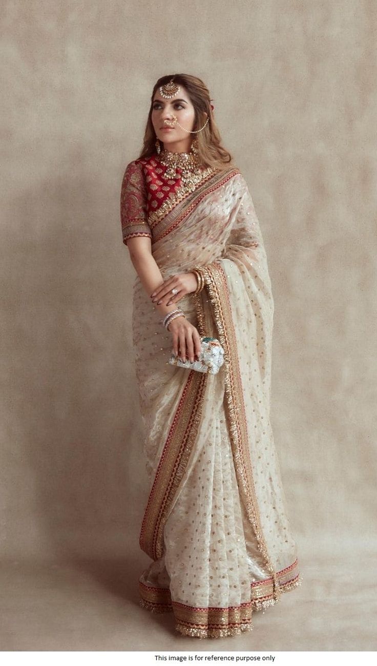 Bollywood Replica SareeBollywood Sabyasachi inspired beige and red silk based wedding sareeBeige Wedding saree in Jimmy Choo silk-based fabric with banglori silk material blouse as unstitched with heavy work. The item has zari,dori,3mm,5mm, and 9mm sequins work with a gold fringe border work on saree.Shipping time is 5-7 days.Buy this Lehenga at Kollybollyethnics and make your occasion very special !!. With Express Free Shipping and Custom Stitching, Shop Bollywood Sabyasachi inspired beige and Saree Wearing Styles, Sari Design, Perhiasan India, Indian Bride Outfits, Fashionable Saree Blouse Designs, Fancy Sarees Party Wear, Indian Saree Blouses Designs, Chique Outfits, Indian Fashion Saree