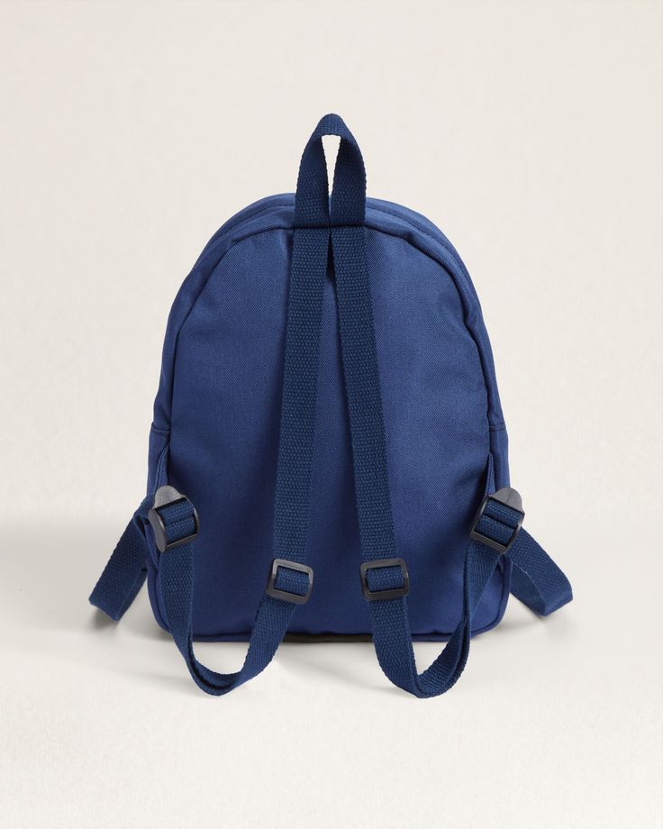 Experience effortless organization and durability with our Opal Springs Canopy Mini Backpack. Made from sturdy canvas and coated with matte PVC, this compact backpack is resistant to dirt, stains, and water, making it the perfect choice for any adventure. Features a zip closure, hanging loop, adjustable straps, and multiple pockets, including an interior slip pocket and an exterior zippered pocket with a wipe-clean lining, this backpack is both functional and stylish. Please note, pattern placem Outdoor Activities Softback Backpack With Zipper Pocket, Canvas Backpack With Zipper For Outdoor Activities, Outdoor Softback Backpack With Zipper Closure, Outdoor Softback Backpack, Outdoor Backpack With Zipper Closure Softback, Outdoor Backpack With Adjustable Strap And Softback, Outdoor Activities Softback Backpack With Adjustable Strap, Outdoor Backpack With Adjustable Strap, Navy School Backpack With Adjustable Strap