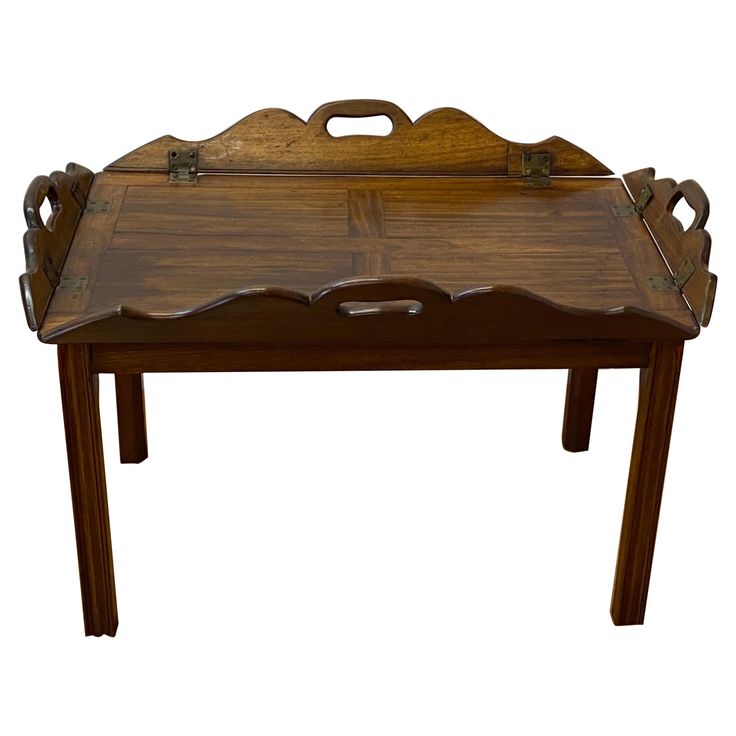 an old wooden tray with handles on the legs is shown in front of a white background