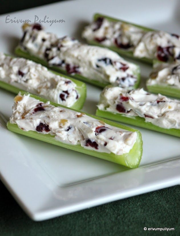 cucumbers with cream cheese and cranberries on them are sitting on a white plate