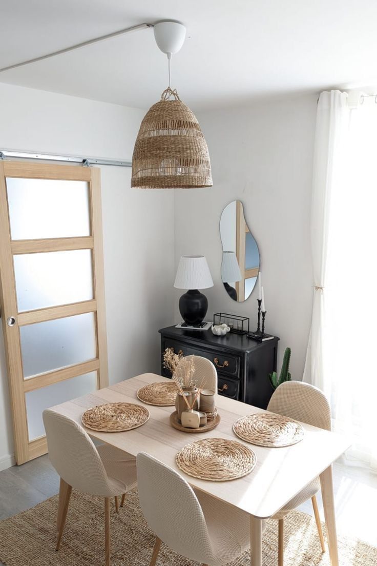 a dining room table with place settings on it and an open door leading to the outside