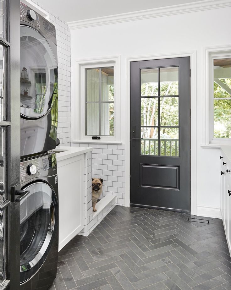 a washer and dryer are in the middle of a room with white walls