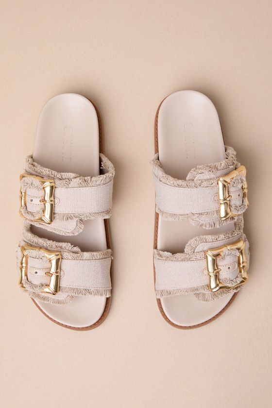 Everyone loves a slide-on sandal for the summertime, and the Schutz Enola Sporty Casual Oyster Buckled Slide Sandals are our favorite pick for this season! These trendy sandals feature an open-toe upper and wide, woven fabric straps with adjustable, chunky gold bamboo-inspired buckles for a statement-making finish. Style with a breezy, wide-leg jumpsuit to keep yourself stylishly cool! 1. 25" sole. Smooth insole. Felted rubber sole has nonskid markings. Man made materials. Imported. Lulus | Enol Chic Summer Footbed Sandals With Buckle Closure, Vacation Open Toe Mules With Buckle Closure, Chic Summer Footbed Sandals With Open Heel, Chic Beige Mules For Vacation, Vacation Footbed Sandals With Textured Footbed And Open Heel, Chic Round Toe Footbed Sandals For Vacation, Cream Open Toe Flip Flops For Vacation, Chic Open Toe Footbed Sandals For Vacation, Open Heel Summer Flip Flops For Vacation