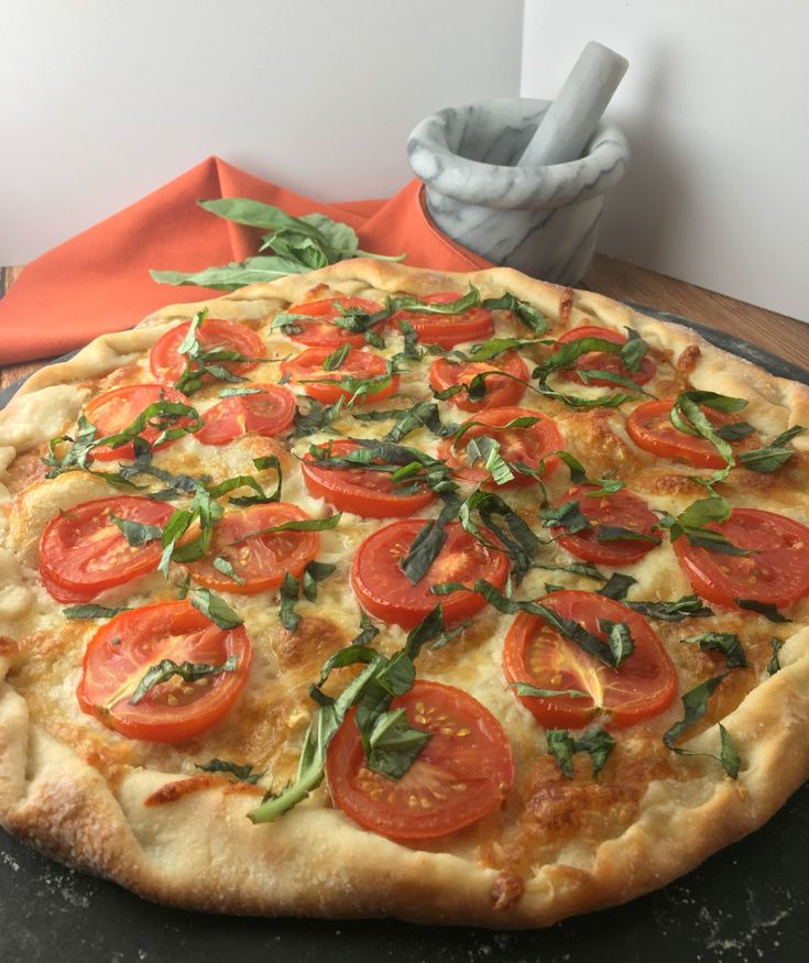 Sliced tomatoes and fresh basil on top of a cheese pizza.  A mortar/pestle, sprig of basil and an orange napkin in the background Pizza With No Tomato Sauce, Pizza Recipes Without Tomato Sauce, Pizza No Tomato Sauce, Pizza Without Red Sauce, Pizza Without Tomato Sauce, Pizza Recipies, Red Pizza Sauce, Fun Meals, Making Pizza