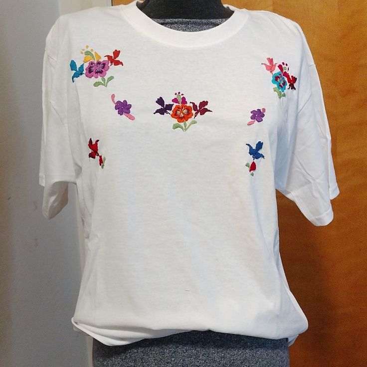 Handmade White Embroidered T-Shirt With Cotton Thread. Size White Embroidered Crew Neck Top, White Crew Neck Top With Embroidered Graphics, White Embroidered T-shirt For Summer, White Floral Embroidered T-shirt, White Short Sleeve T-shirt With Floral Embroidery, White Floral Embroidery Short Sleeve T-shirt, White Floral Embroidered Short Sleeve T-shirt, White Embroidered Casual Shirt, Casual White Embroidered Shirt