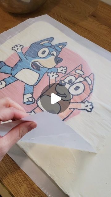 someone is cutting out an image on a piece of paper