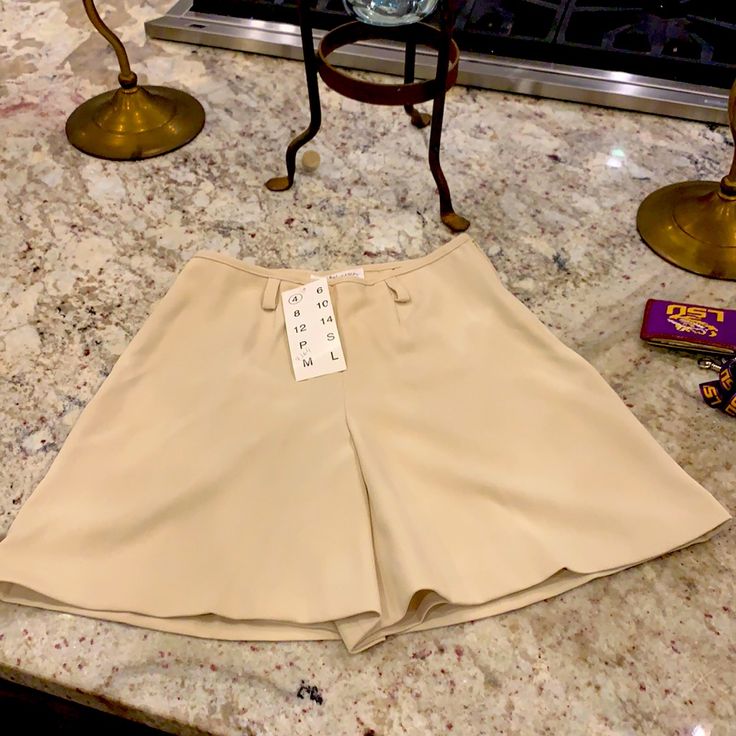 Brand New With Tags. Beautiful Bone Color . See Measurements Size 4 Beige Bottoms With Built-in Shorts For Day Out, Mini Skirt With Built-in Shorts For Day Out, Trendy Beige Wide-leg Shorts, Elegant High Waist Shorts For Day Out, Beige Fitted Short Skort, Fitted Beige Short Skort, Chic Mini Shorts With Pockets, Summer Short Denim Skirt, Fitted Beige Mini Skirt