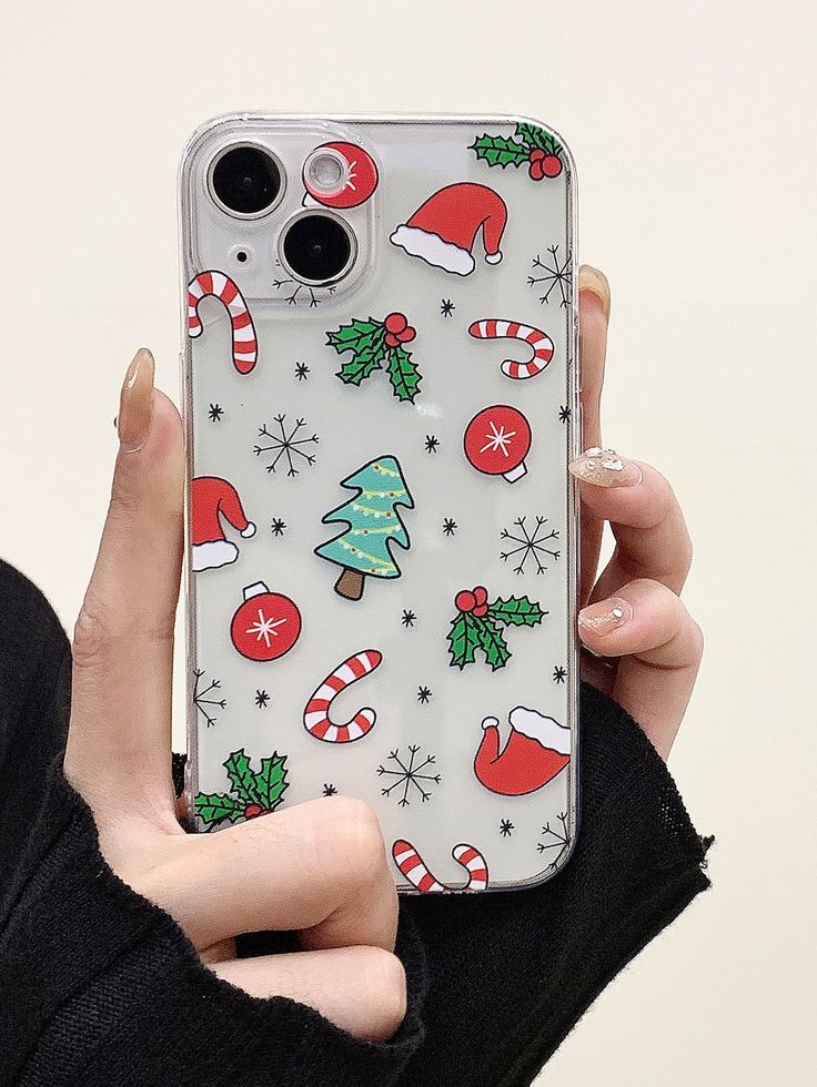 a person holding up a phone case with christmas decorations on it