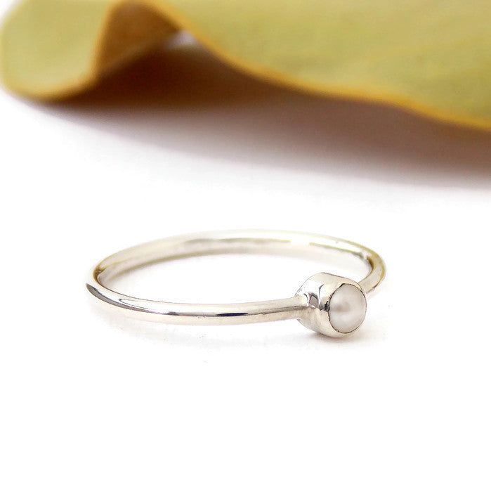 This Mini Freshwater Pearl Ring is made from sterling silver and set with a 3mm white, pink, or black real freshwater pearl. The pearl is tube set with a plain band for a minimalist design. This petite ring is perfect for stacking and makes for and excellent Valentine's Day, Mother's Day, bridesmaid, or anniversary gift. It's small, simple, modern and literally perfect for any occasion.Pearls are known as a birthstone for June. Solid Sterling Silver 3mm White Freshwater Pearl Stackable Pearl Ring In White Gold With Round Band, Stackable White Gold Pearl Ring With Round Band, Minimalist White Moonstone Ring In Sterling Silver, Minimalist Everyday Pearl Ring With Round Band, Adjustable Minimalist Moonstone Ring In Sterling Silver, Minimalist Adjustable Sterling Silver Moonstone Ring, Dainty Sterling Silver Pearl Ring For Everyday, Dainty Stackable Sterling Silver Pearl Ring, Minimalist Stackable Adjustable Pearl Ring