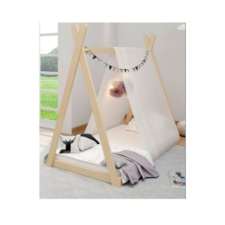 a child's bed with a teepee tent on the bottom and canopy over it