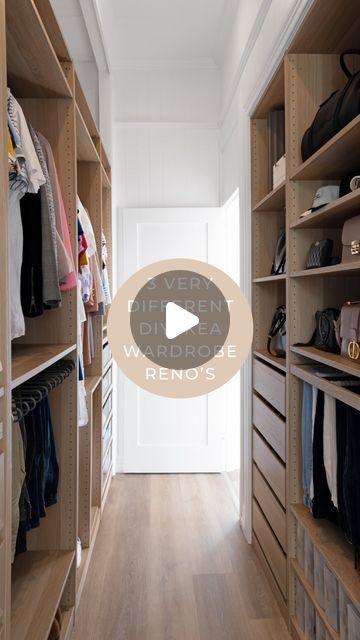 a walk - in closet with wooden shelves and clothes hanging on the walls, along with a door that leads to another room