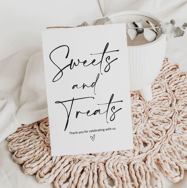 there is a sign that says sweets and treats on the bed next to some blankets