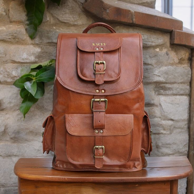 Personalized Leather Backpack Rucksack Travel Bag Laptop Bag Custom Gifts Birthday Gifts, Graduation Gifts, Gifts for Him / Her, Monogram Leather Bag Christmas Gift Vintage Travel Backpack Purse Weekender Bag Specifics - Size: Available in three sizes 16 inch x 11 inch x 8 inch 18 inch x 12 inch x 8 inch 21 inch x 12 inch x 8 inch Color: Brown Closure: Buckles and Drawstring Features: - 2 Front Pocket - 2 Side Pocket  - Inner Zipper Pocket - Padded Compartment for Laptop - Spacious Main Compartm Large Capacity Leather Backpack For Adventure, Large Capacity Rectangular Leather Backpack For Adventure, Brown Satchel Backpack For Gift, Vintage Rectangular Backpack With Pockets, Large Capacity Backpack Gift, Brown Backpack For Gift, Rectangular Large Capacity Backpack Gift, Large Capacity Backpack Satchel Gift, Rectangular Leather Backpack For Adventure