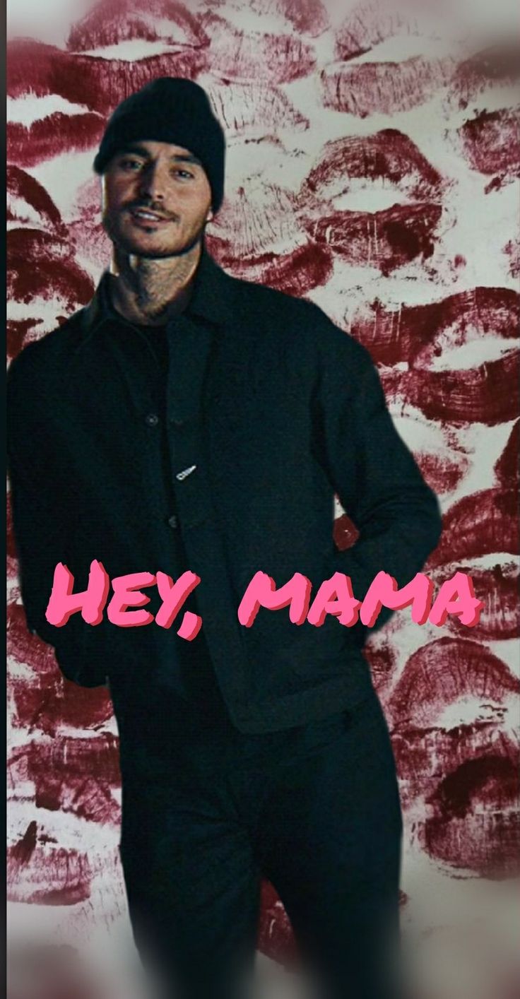 a man standing in front of a red and white background with the words hey mama on it