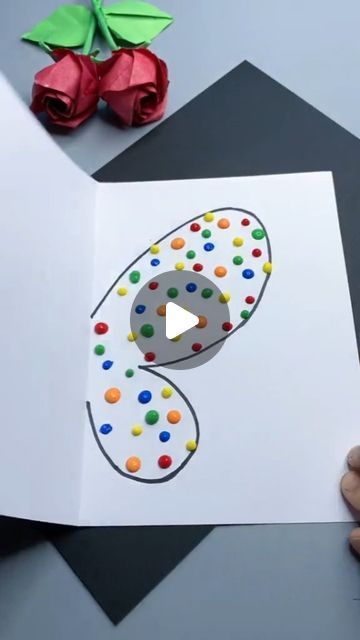 someone is cutting out a paper number for a birthday card with the letter s on it