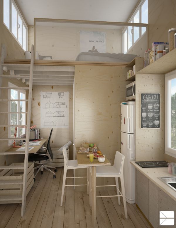 a small kitchen and dining area in a tiny home with stairs leading to the loft