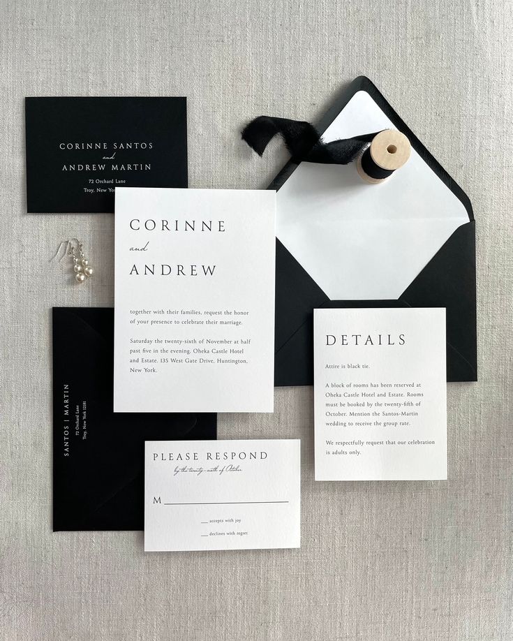 black and white wedding stationery suite with matching envelopes, cards, and tie