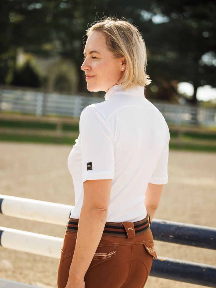 The all new Vital Short Sleeve Sun Shirt combines style, comfort, and flattering lines. This UPF 50 sun shirt features lightweight fabric that is wicking, fast drying, breathable, and pill-resistant. This polished shirt is available in black and white to outfit with any breeches! UPF 50 sun protection 1/4 zip neckline Moisture wicking and fast drying Antimicrobial protection and pill-resistant White Summer Sports Shirt, Fitted Sports Tops With Upf 50+, White Athleisure T-shirt For Outdoor, Casual White Tops With Upf 50+, Fitted Upf 50+ Tops For Outdoor, Breathable White Sports Shirt, White Breathable Sports Shirt, Sporty Short Sleeve Tops With Upf 50+, White Upf 50+ Sports Tops