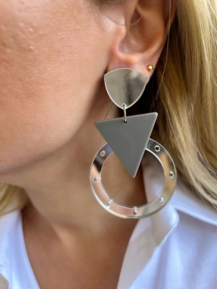 A handmade pair of dangle earrings in Mirror Silver - Gray colors that are made from plexiglass. The result of this shapes combination created a modern design for every woman. They open and close with clip and they could be the ideal pair of earrings for all the summer period. In Christina Christi Jewels store you can see a lot of designs in Women's Earrings. You can have them in 2-4 Days with DHL EXPRESS SHIPPING MATERIALS - Metal parts. - Plexiglass parts DIMENSIONS - Total length of Earrings: Modern Handmade Metal Hoop Earrings, Everyday Silver Triangle Earrings, Modern Metal Dangle Clip-on Earrings, Modern Handmade Silver Plug Earrings, Handmade Trendy Silver Plug Earrings, Handmade Modern Silver Plug Earrings, Trendy Handmade Silver Plug Earrings, Modern Silver Triangle Earrings, Modern Handmade Clip-on Earrings