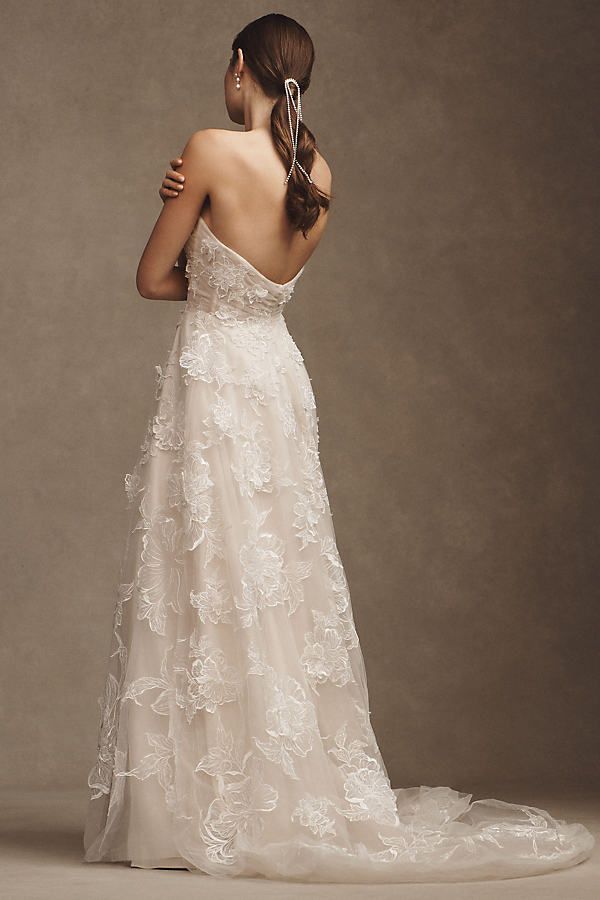 a woman in a wedding dress looking back