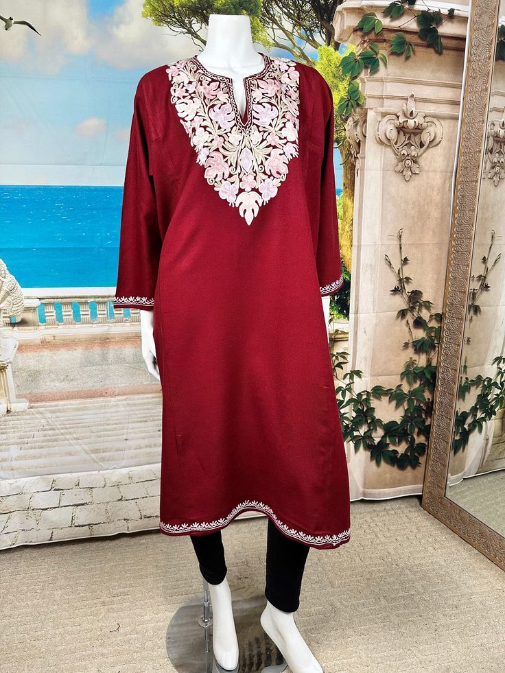 Elevate your winter wardrobe with our traditional Kashmiri Pheran crafted from a mix of wool fabrics, complete with two side pockets and delicate Ari work embroidery. Inspired by centuries of Kashmiri tradition, these Pherans offer both warmth and elegance, perfect for cold weather outings. The intricate till work embroidery adds a touch of sophistication to this timeless garment, making it a must-have for any discerning fashion enthusiast. Stay cozy and stylish with our Kashmiri Pheran, blendin Elegant Floral Embroidered Kurta For Winter, Festive Semi-stitched Long Sleeve Kaftan, Festive Long Sleeve Semi-stitched Kaftan, Semi-stitched Long Sleeve Kaftan For Festive Occasions, Winter Kurta With Intricate Embroidery, Festive Long Sleeve Kaftan With Zari Work, Designer Winter Kurta With Floral Embroidery, Festive Long Sleeve Kaftan With Dabka Work, Winter Embroidered Fitted Kurta