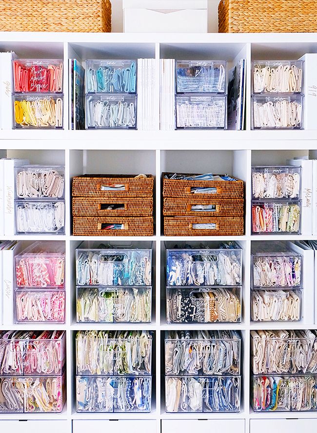 an organized closet with lots of drawers and baskets