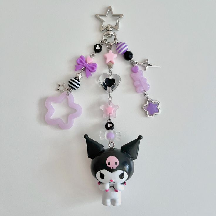 a keychain with various charms attached to it's sides on a white surface