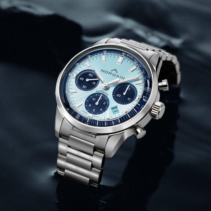 The Freedom collection is strongly tied to an appreciation of the great outdoors that carries across generations. The vintage-inspired design elements including the sky blue dial evoke the aesthetics of the 60s. CASE Material: 316L stainless steel case Diameter: 40.00mm Thickness: 14.90mm Width between lugs: 20.00mm Lug to lug: 49.20mm Water resistance: 100m Double anti-reflective, scratch-proof, box type sapphire glass on top Open case back with scratch-proof flat sapphire glass Screwed-down crown with NORQAIN logo Engraved 316L stainless steel NORQAIN Plate on the left side of the case Bezel: 316L stainless steel bezel DIAL Sky blue dial with sunray finish White tachymeter scale on dark blue outer ring Dark blue counters at 3, 6 and 9 o’clock Diamond-cut flat indexes, with white printing Modern Blue Automatic Watch Accessories, Modern Blue Watch With Subdials, Modern Blue Chronograph Watch, Modern Blue Chronograph Watch Accessories, Modern Blue Chronograph Watch For Business, Business Watches With Blue Metal Dial, Blue Business Watches With Metal Dial, Business Blue Watches With Metal Dial, Modern Blue Watch With Metal Dial