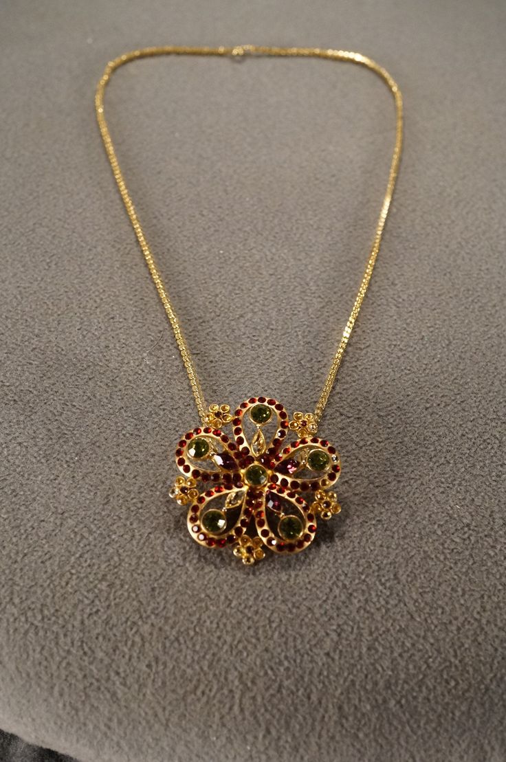 I am offering this fabulous vintage yellow gold tone necklace. This piece is truly gorgeous, and it has the following features:  * beautiful vintage necklace * rhinestone * floral design * glass beads * dangle * 16 inches in length This is a fantastic and classic piece. There is tons of sparkle and shine with this piece. It will beautifully complement your upcoming fashion season. Buyer pays all shipping and handling. Vintage Jeweled Necklaces For Anniversary, Costume Rhinestone Necklace For Gifts, Antique Rhinestone Necklace For Gift, Luxury Art Deco Yellow Gold Necklace, Vintage 14k Gold-tone Necklace, Vintage Gold Rhinestone Necklace With Sparkling Stones, Antique Rhinestone Necklace Gift, Vintage Jeweled Rhinestone Necklace Gift, Vintage Gold Jeweled Rhinestone Necklace