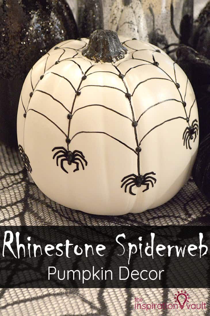 a white pumpkin decorated with black spiderweaves on it and the words, rinestone spiderweb pumpkin decor