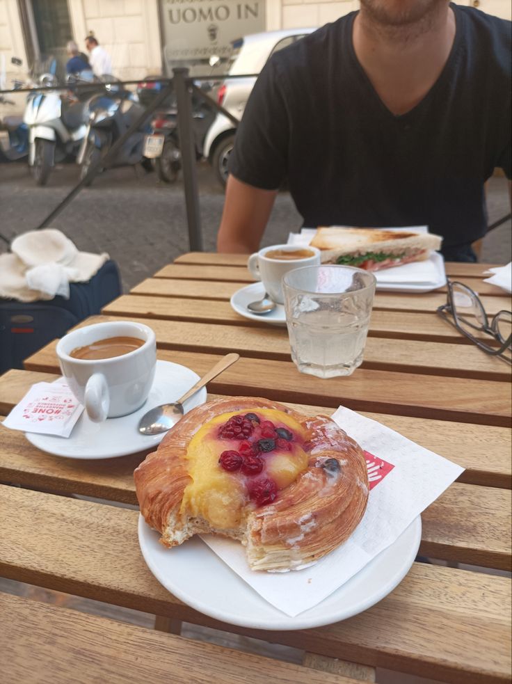 a man sitting at a table with some food on it