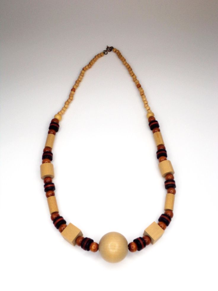 Vintage Hand Crafted Wooden Beaded Necklace with multi shades of tan and brown. Add some80's to your wardrobe. See images for full description. You will receive: (what you see in the images) - 1 Tan & Brown wooden necklace: 24" inches Contact me through Etsy messaging with any questions. All vintage items are hand picked for quality and uniqueness, so you can feel special wearing an authentic piece of the past. Thanks for shopping at Rose & Lily's, check back often for new vintage treasures. Handmade Retro Brown Necklaces, Retro Brown Handmade Necklaces, Retro Handmade Brown Necklaces, Vintage Beige Beaded Necklace, Vintage Beaded Beige Necklace, Vintage Brown Beaded Necklaces With Colorful Beads, Retro Brown Beaded Jewelry, Vintage Brown Necklace With Colorful Beads, Vintage Beige Round Beads Necklace