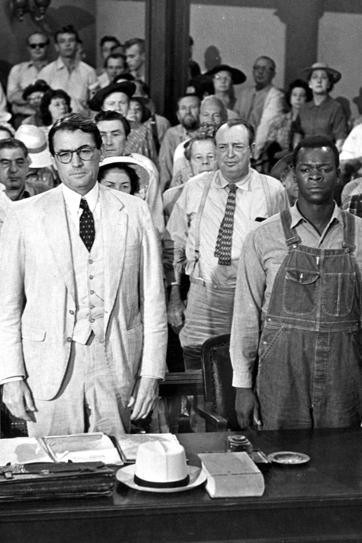 a group of men standing next to each other in front of a crowd