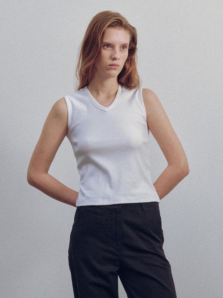 This is a minimal and modern top by NOTHING WRITTEN that is made out of high quality and sturdy material. With distinctive mood of the design and comfortable wear, you can style it for your casual daily outfit.- Minimal and unique V neckline- Cotton fabric with high elasticity- Feminine and modern mood Versatile V-neck Tank Top For Everyday, White Cotton V-neck Top For Everyday, White V-neck Vest Top, Fitted V-neck Top For Everyday, Everyday Cotton V-neck Tank Top, Basic Cotton V-neck Top For Summer, Modern V-neck Tops For Summer, Chic White Stretch V-neck Top, Fitted White Cotton V-neck Top