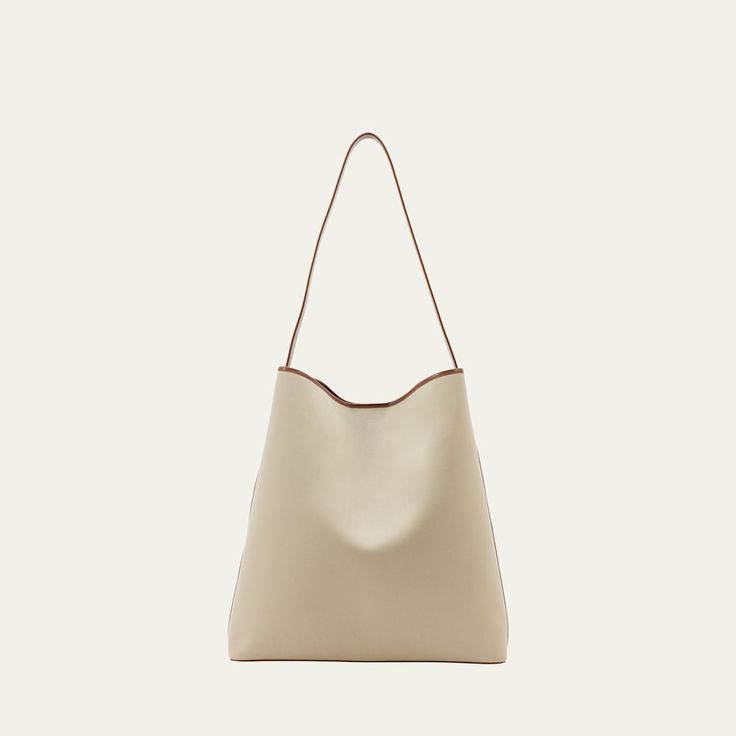 Aesther Ekme "Sac" hobo bag in cotton and faux leather (polyurethane) Shoulder strap  Open top with magnetic closure  Approx. 14.6"H x 14.2"W x 4.3"D Made in Spain Modern Beige Hobo Bag With Detachable Strap, Modern Hobo Bag With Detachable Strap For Shopping, Modern Beige Satchel With Magnetic Closure, Everyday Bucket Bag With Magnetic Closure, Everyday Beige Hobo Bag With Leather Handles, Beige Leather Hobo Bag For Errands, Modern Beige Bag With Magnetic Closure, Cream Hobo Bag With Soft Leather And Double Handle, Modern Everyday Bucket Bag With Magnetic Closure