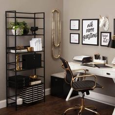 a home office with black and white decor, gold accents and an instrument on the wall