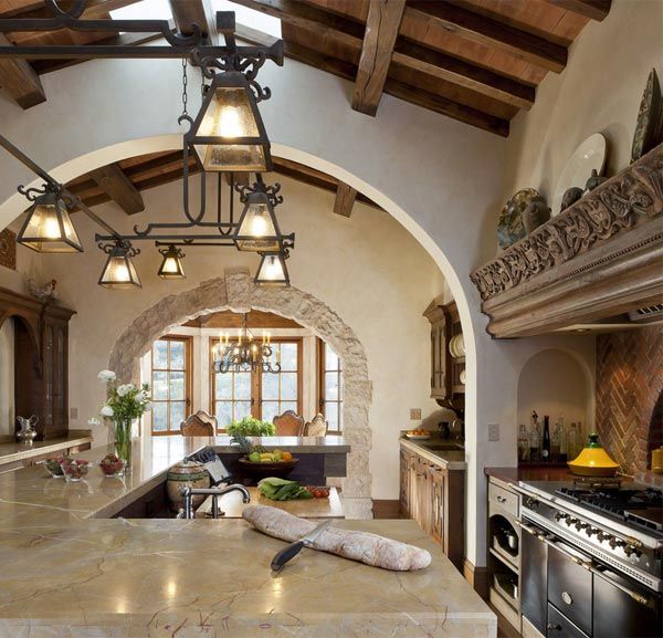 a large kitchen with an arched ceiling and marble counter tops