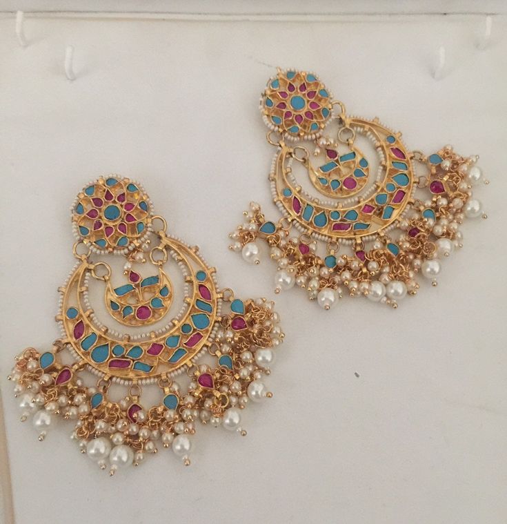 *It is Handmade Chandbali Indian Ethnic Kundan Earrings. *Its made from Silver n Copper with Multi color Kundan pink and turquoise Stones Settings with 22k gold Plating. *It gives Pure Ethnic Look with Antique Touch and is 3.5 inches Long. *Our all jewelry is made from semiprecious stones and beads. *WARRANTY: ITS GENUINE HANDMADE JEWELRY AND WE GIVE LONG LIFE WARRANTY FOR OUR ALL ITEMS. All of our Kundan Jewelry is 100% handmade with ancient Kundan stone setting method using silver foils. It is Traditional Kundan Hoop Earrings With Meenakari, Multicolor Chandbalis With Cutdana For Diwali, Traditional Multicolor Chandbalis With Cutdana, Festival Multicolor Cutdana Chandbalis, Multicolor Chandbali Earrings With Cutdana, Multicolor Chandbali Bridal Earrings With Latkans, Multicolor Chandbali Earrings For Celebration, Multicolor Kundan Danglers With Tilla, Traditional Kundan Hoop Earrings For Diwali