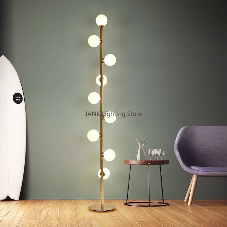 a surfboard is next to a floor lamp in a room with a chair and table